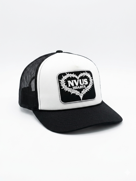 Black and white cap with 'NVUS HEARTS' logo on a light gray background