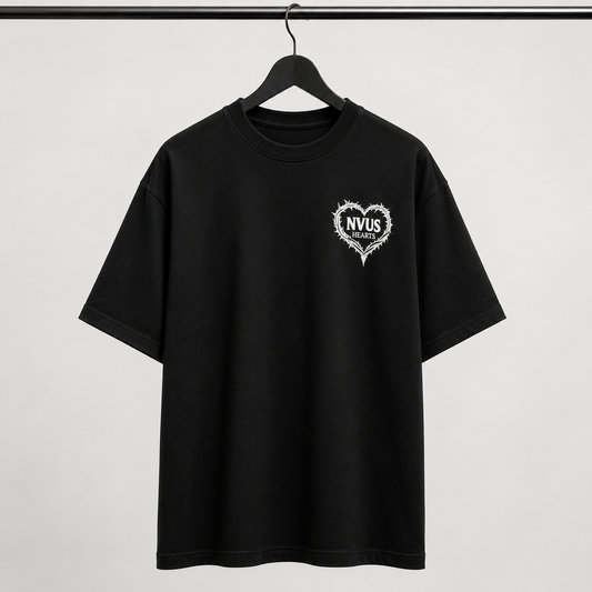 Black t-shirt with a white heart logo on a hanger against a white background